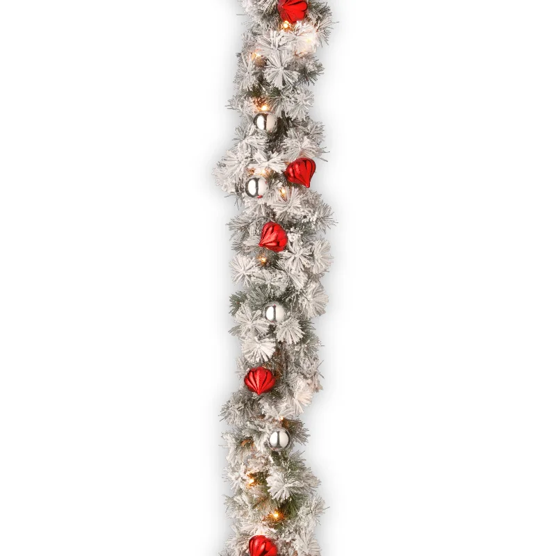 Snowy Christmas 9 ft. Pre-Lit Snowy Bristle Pine Garland with Clear Lights and Ornaments Snowy Christmas 9 ft. Pre-Lit Snowy Bristle Pine Garland with Clear Lights and Ornaments